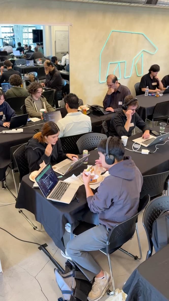 Teams coding at the AI Agents Hackathon at the MindsDB venue